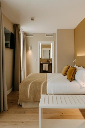 a hotel room with a bed and a table at Hotel Pax Atocha in Madrid
