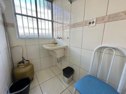 Un baño pequeño con lavabo e inodoro. en Guilhermina 250m do Mar! Com garagem!, en Praia Grande