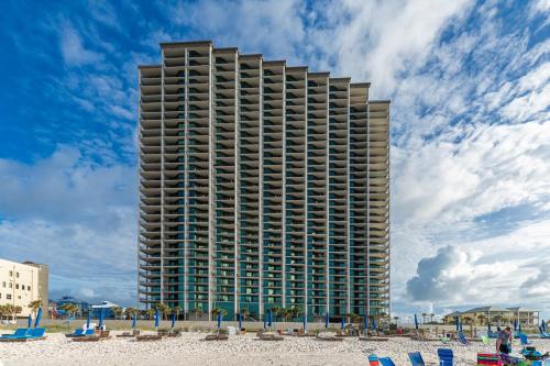 a tall building on the beach next to the beach at The Oasis 2209 formerly Phoenix West II 2209 condo in Romar Beach