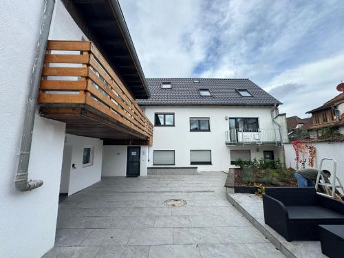 a large white house with a patio at F3 - 1 Zimmer Wohnung in Offenbach