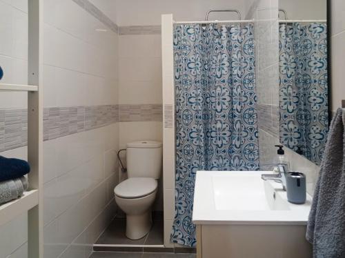 a bathroom with a toilet and a sink and a shower at Easystay Costa del Silencio Wifi in Costa Del Silencio