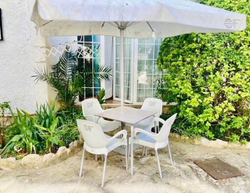 a table and chairs under a white umbrella at AlquilerSalou Loft B in Salou