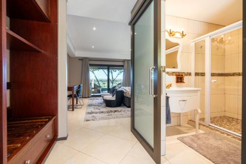 a kitchen with a glass door leading to a living room at Simanya River Lodge in Kanyekama