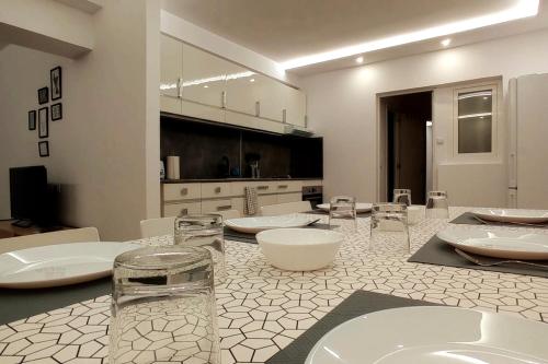 a room with a counter with sinks and chairs at Las Américas Seafront - Free Wi-fi in Costa de Adeje