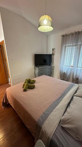 a bedroom with a bed with a green towel on it at VILLA CHRIS Ocean View in La Jaca