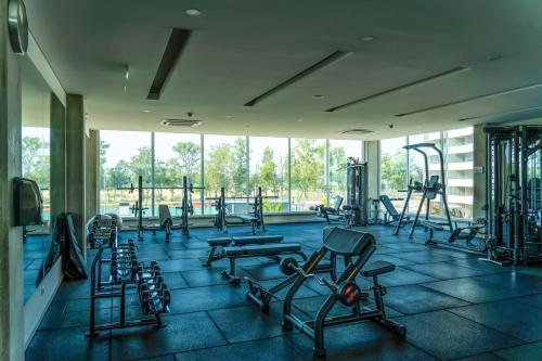 a gym with a lot of exercise equipment in a building at Altamira Surubi-i in Estancia Sarubi