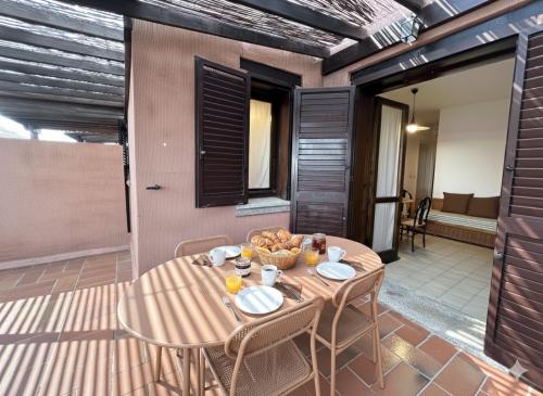 a table with a bowl of food on a patio at 8 ARBOUSIERS VILLA 19 in Bonifacio