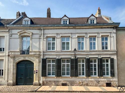 カンブレーにあるLa Demeure Numéro 5の緑の扉が付いた白い大きな建物