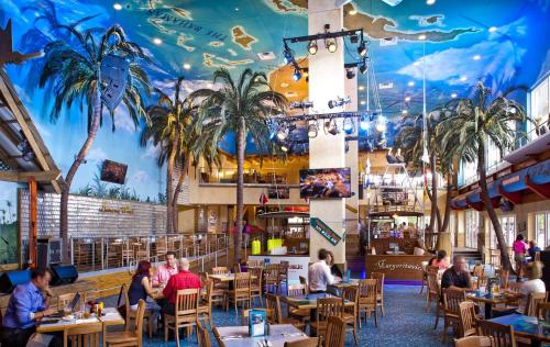 a restaurant with a mural of palm trees on the ceiling at Beach and Down Town Hollywood in Hollywood