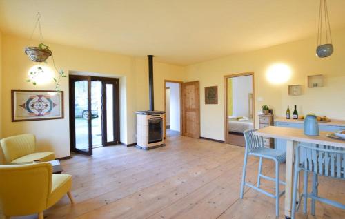 a kitchen and living room with a table and chairs at House in the Shambhalla Forest in Esmate