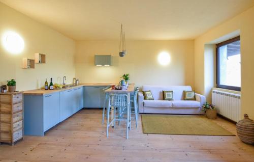 a kitchen and living room with a couch and a table at House in the Shambhalla Forest in Esmate
