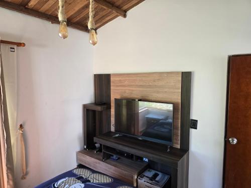 a flat screen tv sitting on a stand in a room at Finca santa helena in Machetá