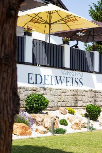 an umbrella in front of a building with the words edgewiss at Wellness Hotel Edelweiss in Liberec