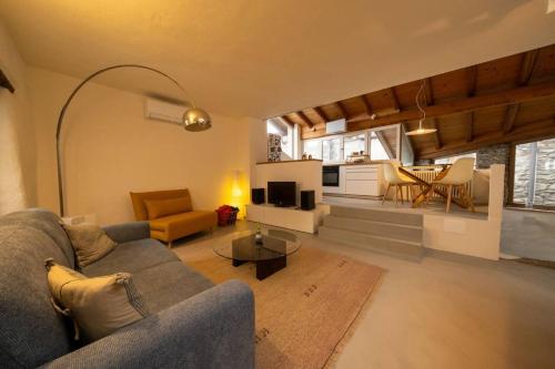 a living room with a couch and a table at Casa Sorel : Attico Lago & Pool in Pianello Del Lario