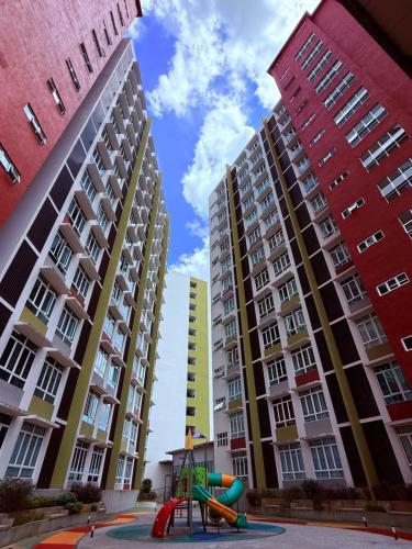 a playground in front of tall apartment buildings at Mahkota Valley Suite, Lemmie Stay in Kuantan