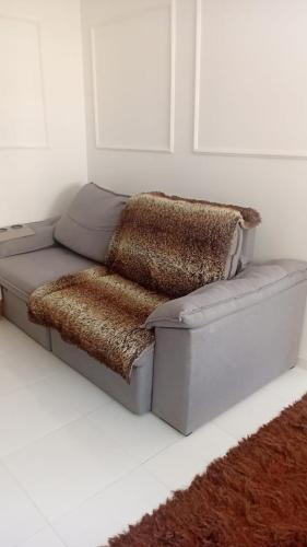 a couch sitting in a room with a rug at Apartamento com ótima localização! in Belém