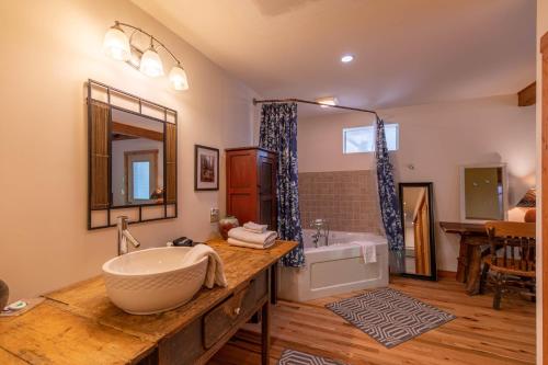 a bathroom with a large tub and a sink at Knotty Pine in West Jefferson