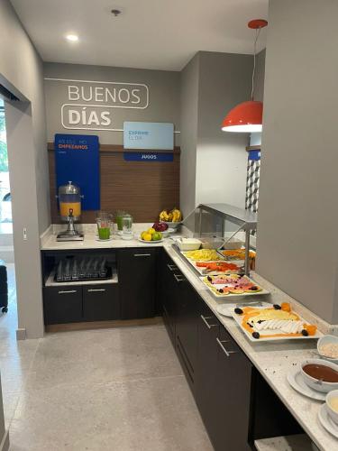 a kitchen with a buffet of food on a counter at Holiday Inn Express Ciudad de Mexico Condesa by IHG in Mexico City