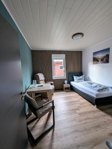 a bedroom with a bed and a desk in it at Ferienwohnung Landkajüte in Twist