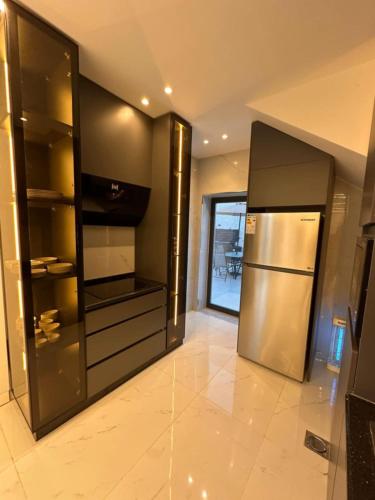 a kitchen with a stainless steel refrigerator in a room at las vegas villa in Ath Thughrah