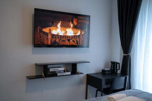 a living room with a fireplace on the wall at Hôtel Sofiane in Paris