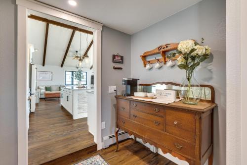 a room with a dresser with a vase of flowers on it at Mtn Views, Hot Tub and Fire Pit Black Hills Retreat in Piedmont