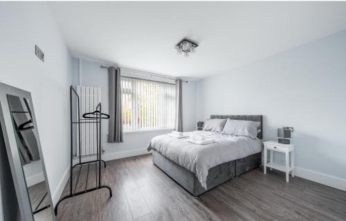 a white bedroom with a bed and a window at Spacious city centre Flat in the heart of Chester in Chester