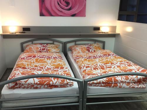 two beds sitting next to each other in a room at Haus Elvira in Horb am Neckar