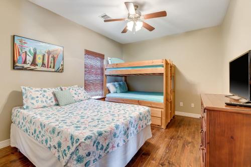 a bedroom with a bunk bed and a tv at Stunning Beachfront Large Deck Sleeps 14 in Caplen
