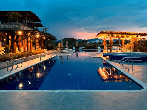 a pool at a resort at night at Hotel El Cielo en la Tierra in Quimbaya