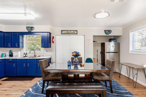 a kitchen with blue cabinets and a table and chairs at Colorful & Cozy 3 Bedroom in Columbus in Columbus