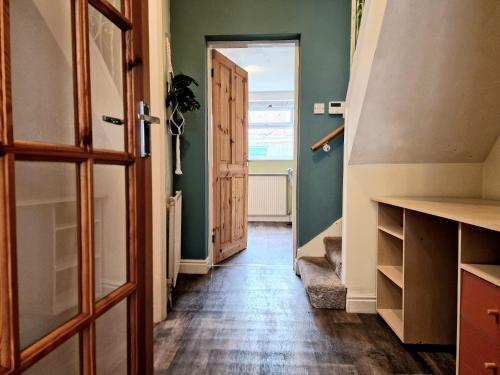 a hallway with a door open to a room at Devon St - Cozy home, Free easy parking! in Hull