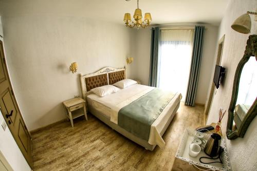 a bedroom with a bed and a large window at Villa Fanti in Cesme