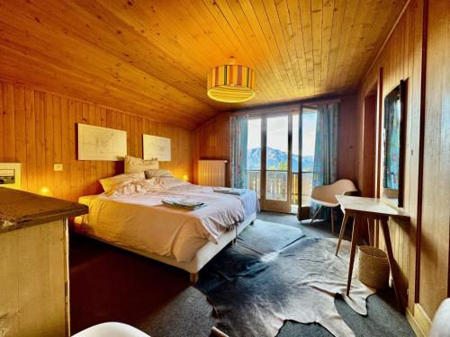 a bedroom with a large bed in a wooden room at Chalet Christina in Verbier