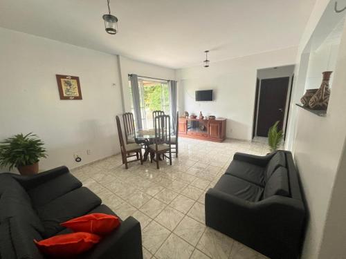 a living room with two couches and a table at COP 30, Mosqueiro - Apto pé na areia in Belém