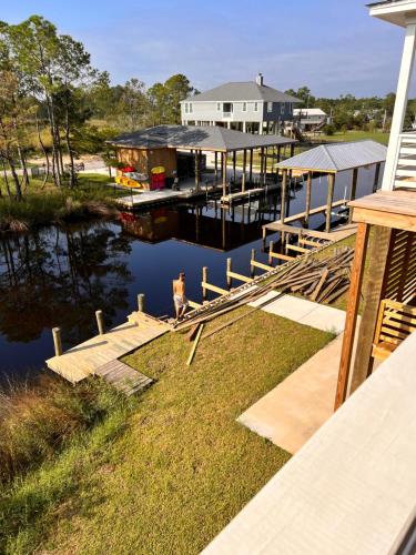 a person standing on a dock next to a marina at The Bay Stay in Shoreline Park