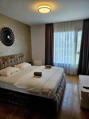 a bedroom with a large bed with a large window at BW Maša in Belgrade