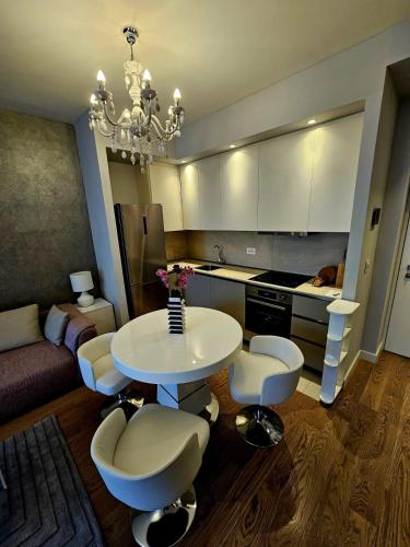 a kitchen with a table and chairs in a room at BW Maša in Belgrade