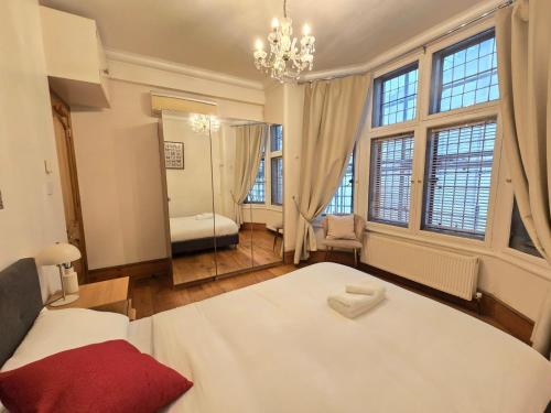 a bedroom with a large bed and a large window at Original Trafalgar Square Apartment near Buckingham Palace in London
