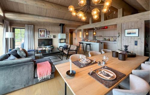 a living room with a couch and a table at Amazing Home In Gålå With Sauna in Gålå