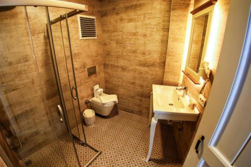 a small bathroom with a toilet and a sink at Villa Fanti in Cesme