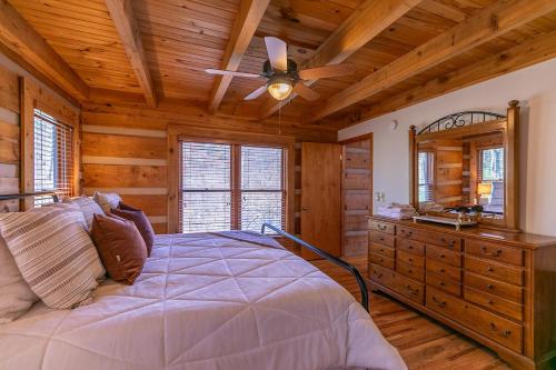 a bedroom with a bed and a ceiling fan at Happy Trees Cabin in Laxon
