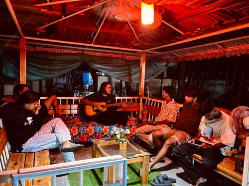 a group of people sitting in a living room at Orchid Home Stay in Cherai Beach
