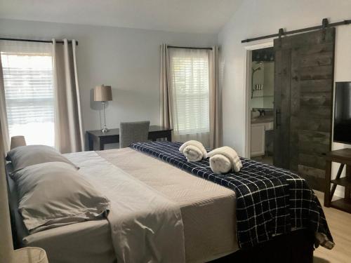 a bedroom with a large bed with towels on it at Maple House w-Private Jacuzzi Near IAH in Humble