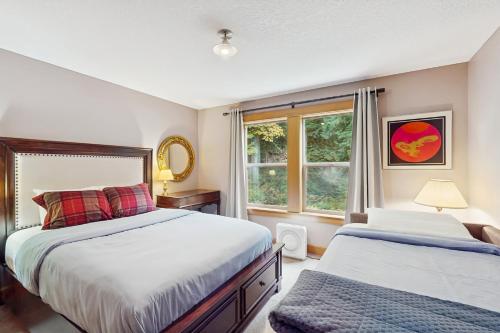 a bedroom with two beds and a window at Riversong Retreat in Welches in Welches