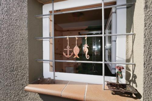 a window with a bunch of hooks in it at La Platjeta in Calonge