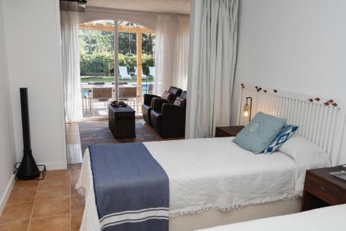 a bedroom with a bed and a living room at La Platjeta in Calonge