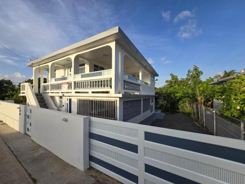 a white house on top of a white fence at Casa Anastasia Beachside Villa with Pool in Vieques