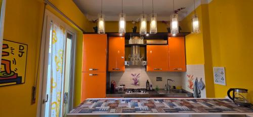a kitchen with yellow walls and orange cabinets at Pisa Happy House in Pisa