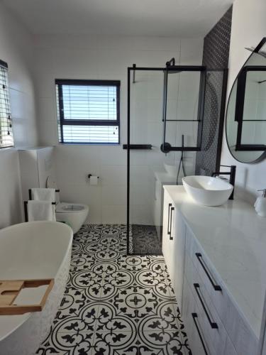 a bathroom with two sinks and a shower and a toilet at Wine Not Relax in Yzerfontein